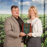 Steve Garrette receiving award from John Deere